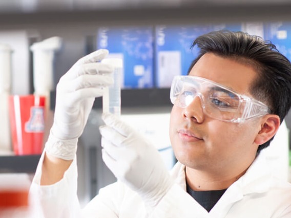 Student examining a test-tube.