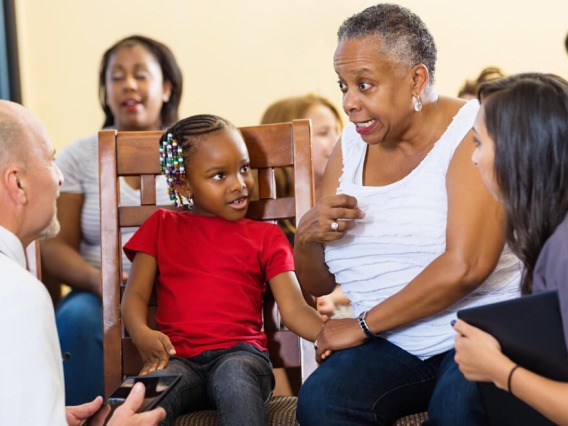 doctor and intern talking with patients in waiting room