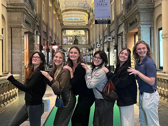 Smiling students lined up for a photo in German museum