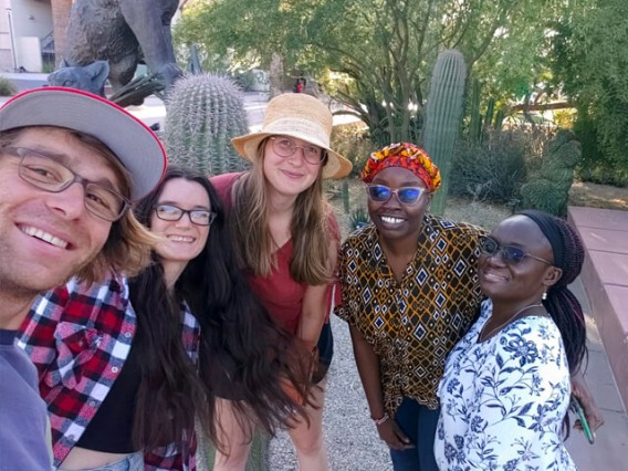 Group of students on U of A campus in front of cactus