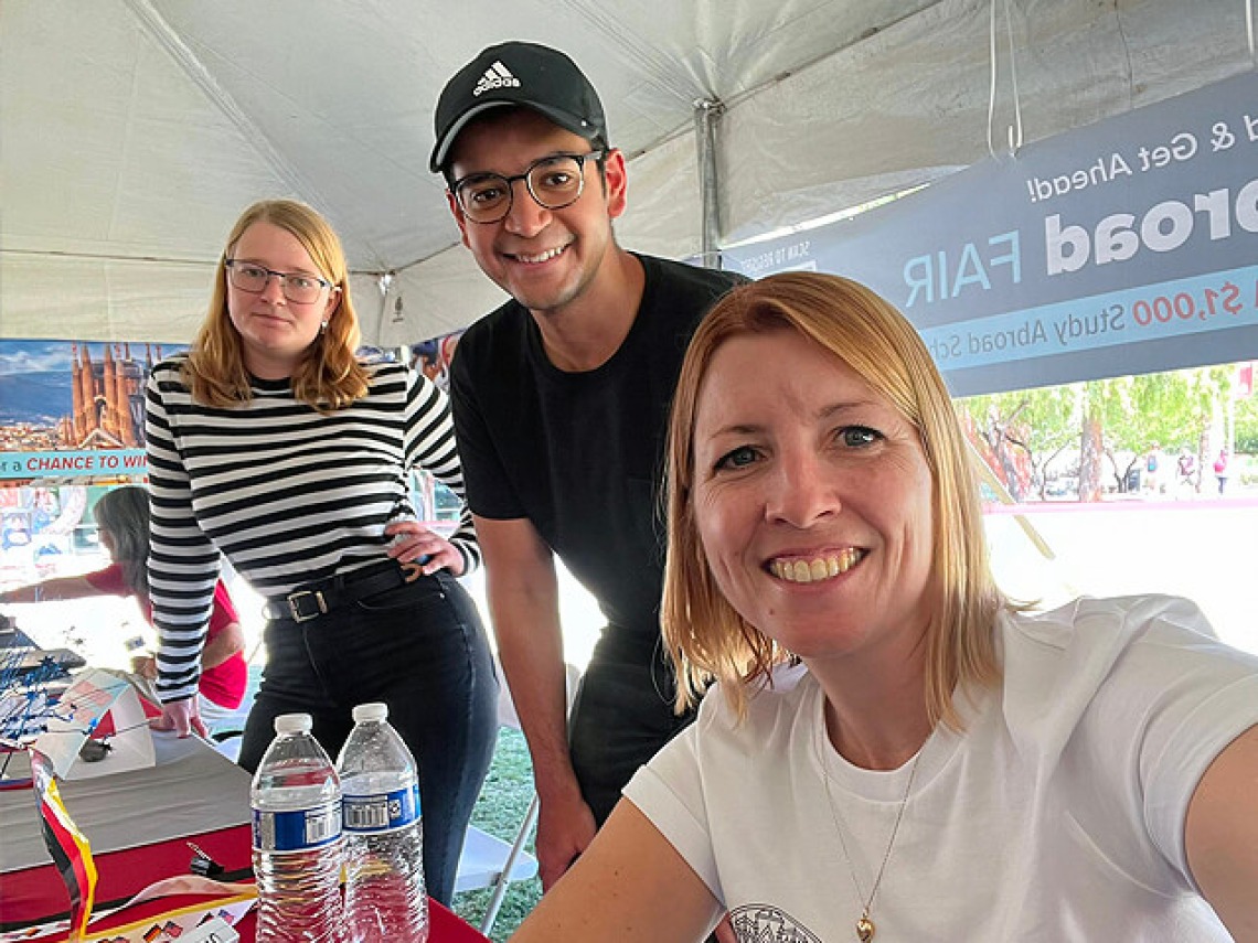 Faculty at an info table on the mall