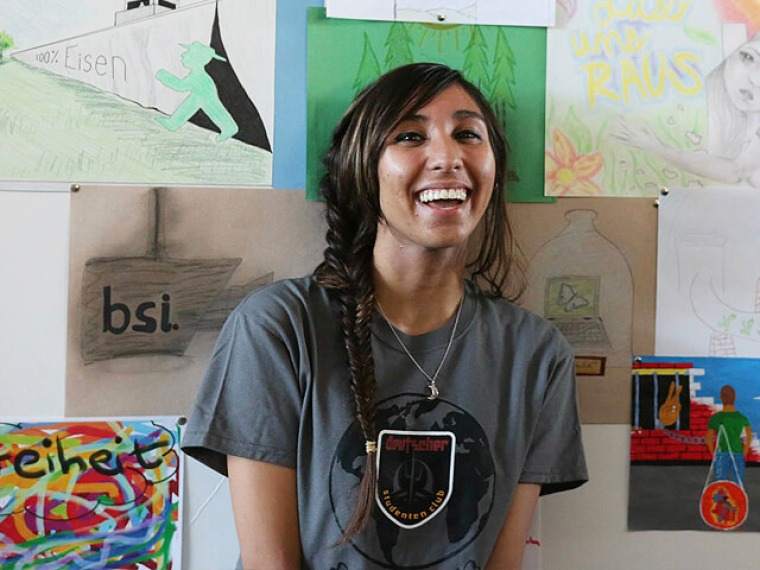 Smiling young woman wearing German Club t-shirt