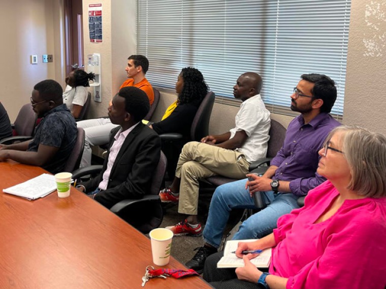 Group of faculty and students listening to a lecture